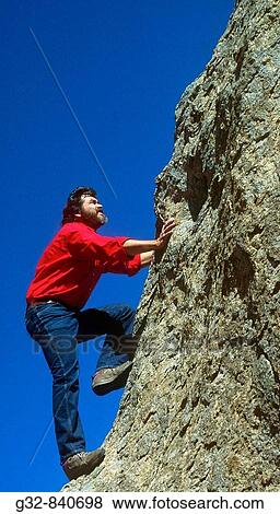 Stock Photo - man climbing rock.. Fotosearch
