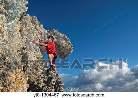 Man climbing rocks View Large Photo Image Stock Photo - Man climbing rocks. Fotosearch