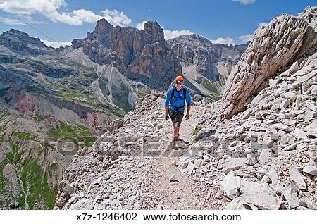 Man climbing the Giovanni Lipella via ferrata on Tofana De Rozes in the Dolomite Mountains near the city of Cortina in northern Italy View Large Photo Image Stock Image - Man climbing the Giovanni Lipella via ferrata on Tofana De Rozes in the Dolomite Mountains near the city of Cortina in northern Italy. Fotosearch