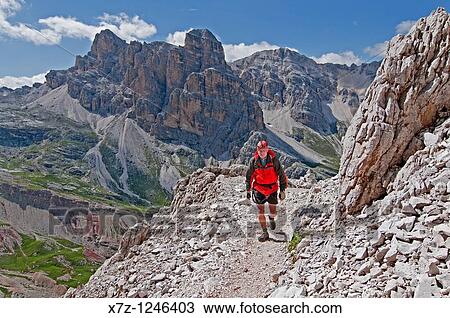 Stock Image - Man climbing the Giovanni Lipella via ferrata on Tofana De Rozes in the Dolomite Mountains near the city of Cortina in northern Italy. Fotosearch