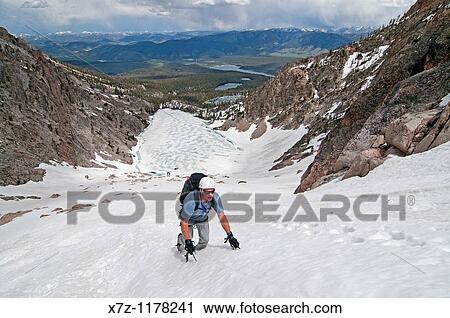 Stock Image - Man climbing the Petzoldt Couloir on Mount Heyburn high in the Sawtooth Mountains of central Idaho. Fotosearch