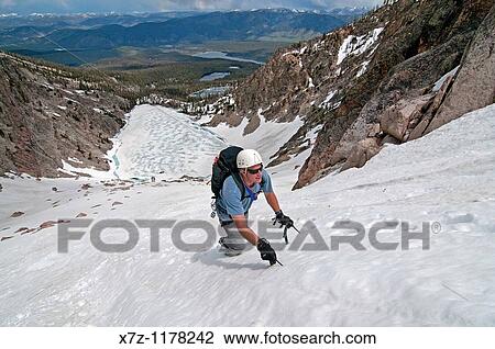 Stock Image - Man climbing the Petzoldt Couloir on Mount Heyburn high in the Sawtooth Mountains of central Idaho. Fotosearch