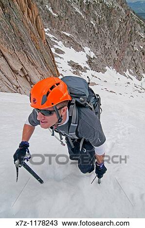 Stock Image - Man climbing the Petzoldt Couloir on Mount Heyburn high in the Sawtooth Mountains of central Idaho. Fotosearch