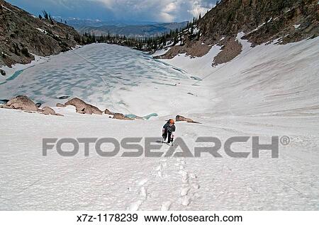 Stock Photo - Man climbing the Petzoldt Couloir on Mount Heyburn high in the Sawtooth Mountains of central Idaho. Fotosearch