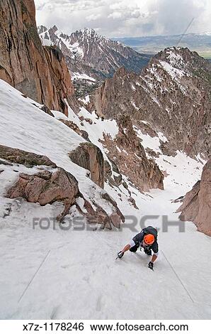 Stock Photograph - Man climbing the Petzoldt Couloir on Mount Heyburn high in the Sawtooth Mountains of central Idaho. Fotosearch