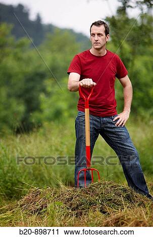 Man collecting cut grass with pitchfork, hand tool, farming, Guipuzcoa, Basque Country, Spain View Large Photo Image Stock Image - Man collecting cut grass with pitchfork, hand tool, farming, Guipuzcoa, Basque Country, Spain. Fotosearch