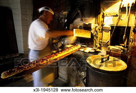 Man cooking cocas, typical pastry of Catalunya. Barcelona. Spain View Large Photo Image Stock Photo - Man cooking cocas, typical pastry of Catalunya. Barcelona. Spain. Fotosearch