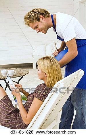 Man cooking with his partner at home View Large Photo Image Stock Photo - Man cooking with his partner at home. Fotosearch