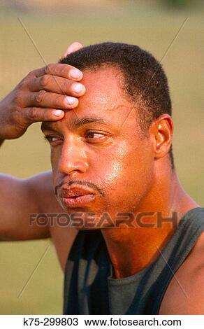 Stock Image - Man cooling down after exercise. Fotosearch