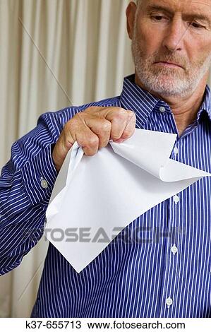 Man crumpling a piece of white paper. View Large Photo Image Stock Image - Man crumpling a piece of white paper.. Fotosearch