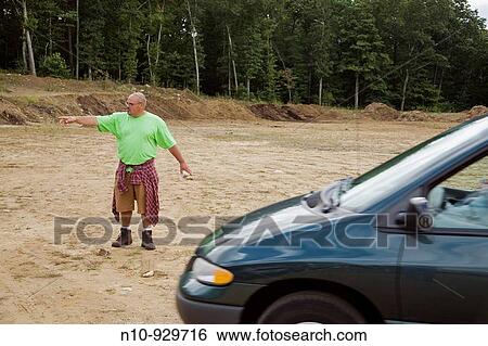 Man directing traffic at a fair View Large Photo Image Stock Photograph - Man directing traffic at a fair. Fotosearch