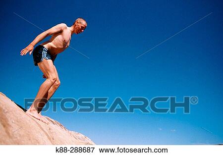 Stock Photo - Man diving in Bohusln, on the west coast of Sweden. Fotosearch
