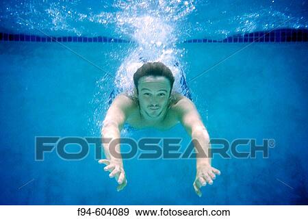 Stock Photo - Man diving into swimming pool. Fotosearch