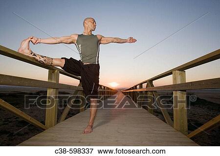 Man Doing a Leg Stretch on Footbridge View Large Photo Image Stock Photo - Man Doing a Leg Stretch on Footbridge. Fotosearch