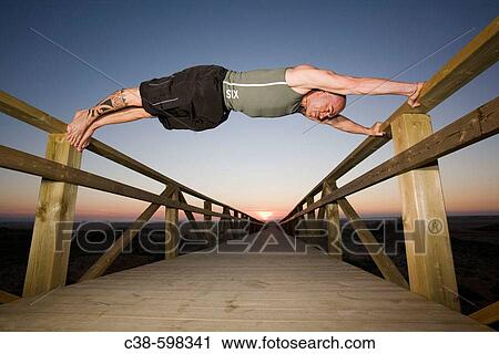 Man Doing Exercise on Footbridge View Large Photo Image Stock Image - Man Doing Exercise on Footbridge. Fotosearch