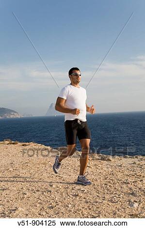 Stock Photography - Man doing some jogging by the sea. Fotosearch
