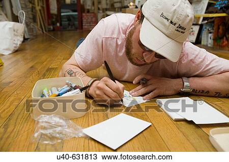 Man drawing pictures laying on the floor View Large Photo Image Stock Image - Man drawing pictures laying on the floor. Fotosearch