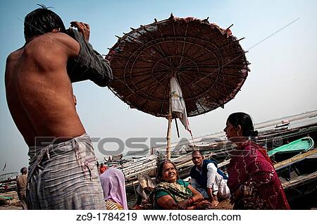 Man dressing in a ghat after bathing in Ganges River Varanasi, India View Large Photo Image Stock Photo - Man dressing in a ghat after bathing in Ganges River Varanasi, India. Fotosearch