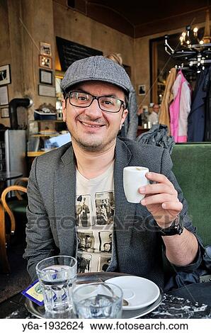 Man drinking coffee in cafe View Large Photo Image Picture - Man drinking coffee in cafe. Fotosearch