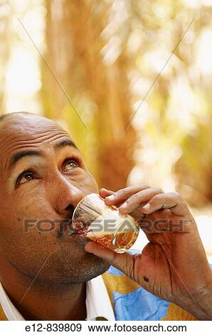 Man drinking tea, Chinguetti. Adrar Plateau, Sahara Desert, Mauritania View Large Photo Image Stock Photo - Man drinking tea, Chinguetti. Adrar Plateau, Sahara Desert, Mauritania. Fotosearch