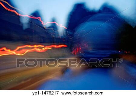 Man driving a motorbike at dusk on a country road among the limestone peaks, Guangxi, China. View Large Photo Image Stock Photo - Man driving a motorbike at dusk on a country road among the limestone peaks, Guangxi, China.. Fotosearch