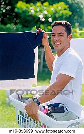 Man drying clothes View Large Photo Image Stock Photo - Man drying clothes. Fotosearch