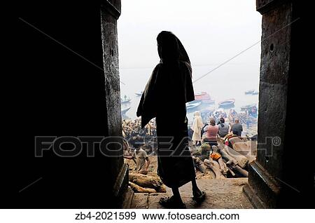 Man during the Hindu cremation ceremony at Manikarnika Ghat on banks of holy Ganges river, Varanasi, Benares, Uttar Pradesh, India, Asia. View Large Photo Image Stock Photo - Man during the Hindu cremation ceremony at Manikarnika Ghat on banks of holy Ganges river, Varanasi, Benares, Uttar Pradesh, India, Asia.. Fotosearch