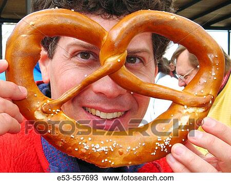 Man, early 40s, holding large pretzel, Kloster Andechs beer garden, near Munich, Germany View Large Photo Image Stock Image - Man, early 40s, holding large pretzel, Kloster Andechs beer garden, near Munich, Germany. Fotosearch