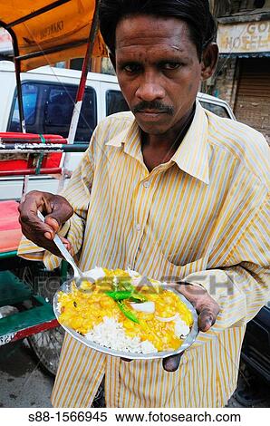Man eating beans curry for breakfast on the street View Large Photo Image Stock Photography - Man eating beans curry for breakfast on the street. Fotosearch