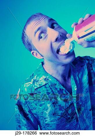 Man eating whipped cream View Large Photo Image Stock Photograph - Man eating whipped cream. Fotosearch