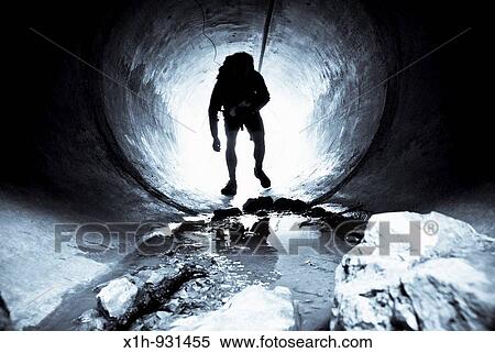 Man emerging from a tunnel, Serres, Hautes-Alpes, Southern France View Large Photo Image Stock Photography - Man emerging from a tunnel, Serres, Hautes-Alpes, Southern France. Fotosearch
