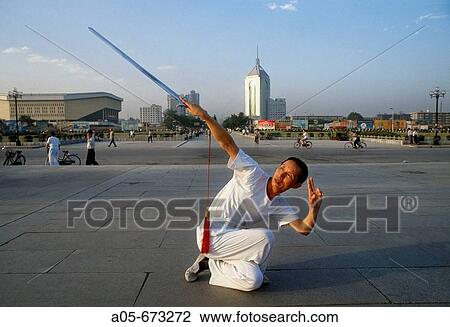Man exercising with swords in the morning. Slow moves. Xi? ian city. Shaanxi province. China. View Large Photo Image Stock Image - Man exercising with swords in the morning. Slow moves. Xi? ian city. Shaanxi province. China.. Fotosearch