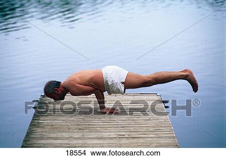 Picture - Man exercising yoga. Fotosearch