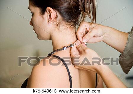 Man fastening woman's necklace View Large Photo Image Stock Image - Man fastening woman's necklace. Fotosearch