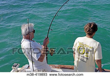 Man fishing from a boat in Marathon, Florida. USA. December 2004. View Large Photo Image Stock Image - Man fishing from a boat in Marathon, Florida. USA. December 2004.. Fotosearch