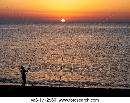 Man fishing in the sunset at Capo d? orlando, Siciliy View Large Photo Image Stock Image - Man fishing in the sunset at Capo d? orlando, Siciliy. Fotosearch