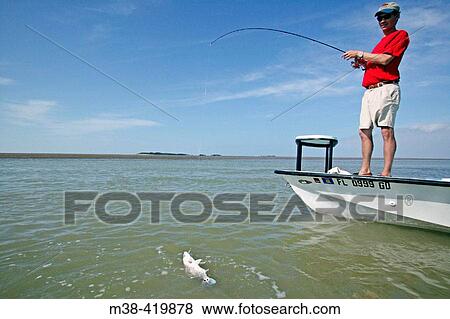 Man fishing off a boat in Islamorada, Florida. December 2004. View Large Photo Image Stock Photo - Man fishing off a boat in Islamorada, Florida. December 2004.. Fotosearch