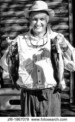 Man fishing with fish in Canada with Waleye Northern Pike. View Large Photo Image Stock Photo - Man fishing with fish in Canada with Waleye Northern Pike.. Fotosearch