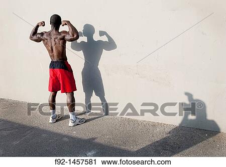 Man flexing muscles View Large Photo Image Stock Image - Man flexing muscles. Fotosearch