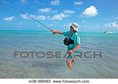 Man fly fishing in Jumby Bay in Antigua View Large Photo Image Stock Image - Man fly fishing in Jumby Bay in Antigua. Fotosearch