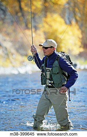 Man fly fishing on the Big Wood River in Sun Valley, Idaho. USA View Large Photo Image Stock Photography - Man fly fishing on the Big Wood River in Sun Valley, Idaho. USA. Fotosearch