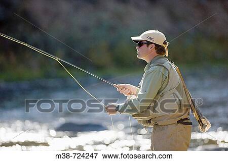 Man fly fishing on the Gallatin River, Near Big Sky, Montana, USA View Large Photo Image Stock Photo - Man fly fishing on the Gallatin River, Near Big Sky, Montana, USA. Fotosearch