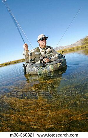 Man flyfishing on a float tube on Silver Creek, Idaho. USA View Large Photo Image Stock Image - Man flyfishing on a float tube on Silver Creek, Idaho. USA. Fotosearch
