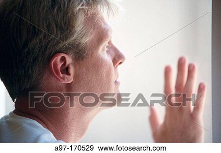 Man gazing out window View Large Photo Image Stock Photo - Man gazing out window. Fotosearch