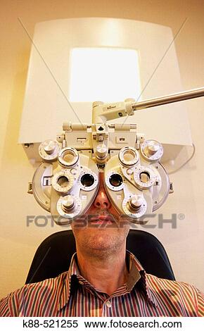 Stock Photography - Man getting an eye exam. Fotosearch
