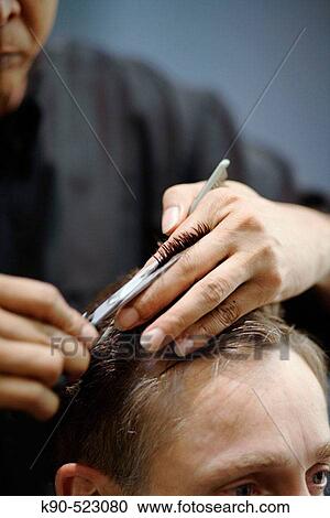 Stock Image - Man getting hair cut. Fotosearch