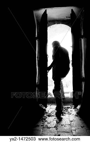 Man getting out of an old door View Large Photo Image Stock Image - Man getting out of an old door. Fotosearch