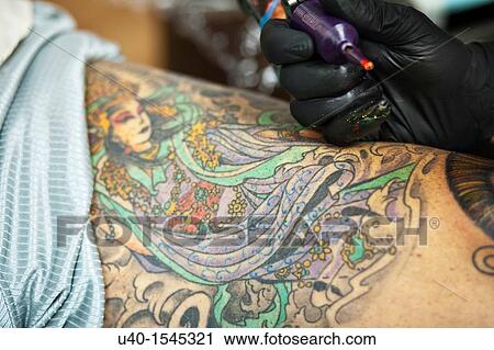 Man getting tattoo on knee View Large Photo Image Stock Image - Man getting tattoo on knee. Fotosearch