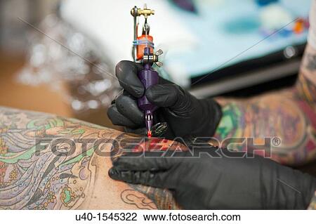 Man getting tattoo on knee View Large Photo Image Stock Image - Man getting tattoo on knee. Fotosearch