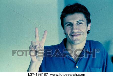 Man giving peace sign View Large Photo Image Stock Photo - Man giving peace sign. Fotosearch